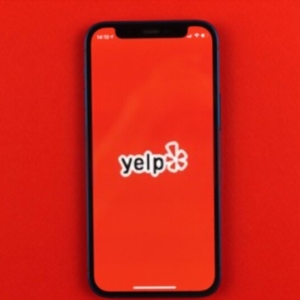MMR cited favorably as client wins long-running lawsuit YELP lawsuit image on phone